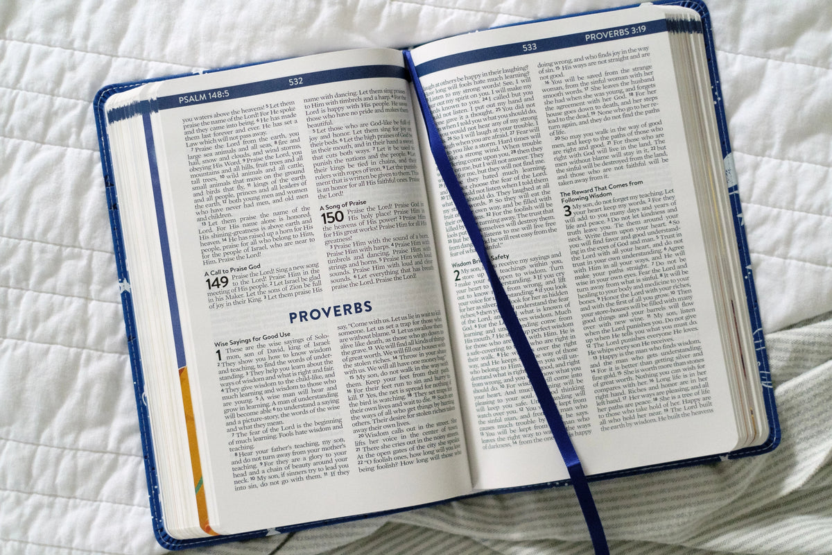 Kids' Bedtime Devotional Bible, open to Proverbs pages with ribbon marker