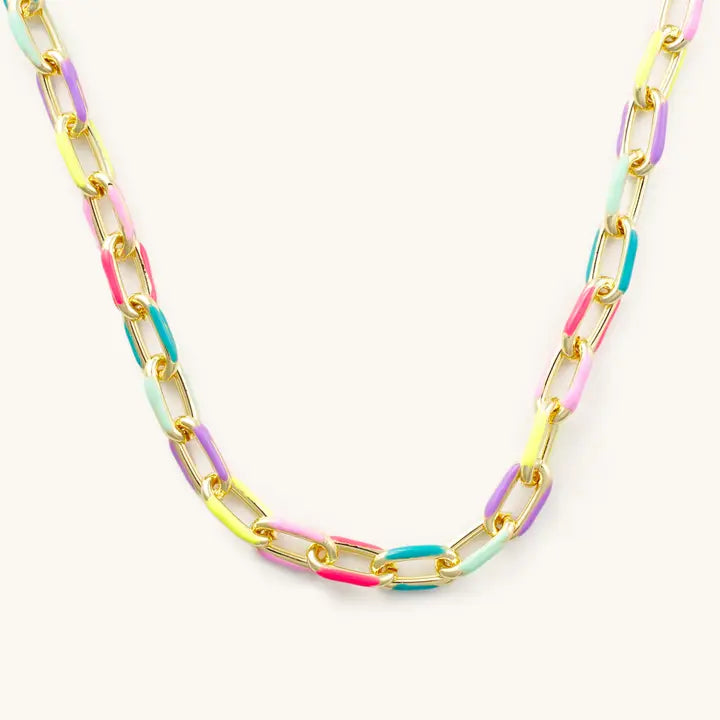Pippa gold paperclip necklace with pink, lavender, yellow, mint and turquoise-blue accents on a light background.