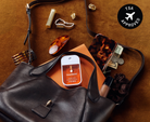 Touchland Spiced Pumpkin-Tini Power Mist in a black leather bag with TSA approved badge