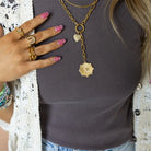 Laney Lariat Gold Charm Necklace worn by a model over a gray ribbed tank