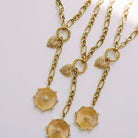 Laney Lariat Gold Charm Necklace, three lariats with heart and round medallion charms on white