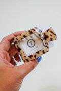 TELETIES Small Blonde Tortoise Square Hair Clip held in hand, front view