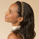 Woman wearing a decorative headband against a beige background