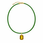 Quin Pendant Necklace in green cord with yellow jewel pendant on a white background