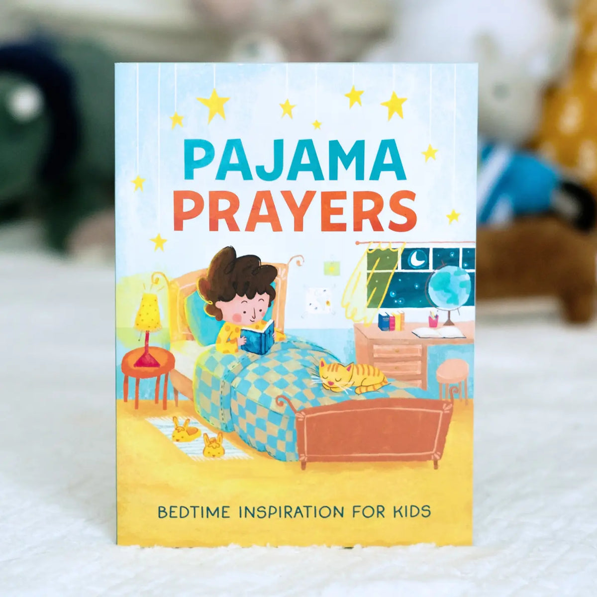 Pajama Prayers bedtime inspiration book for kids, front cover standing on a bed
