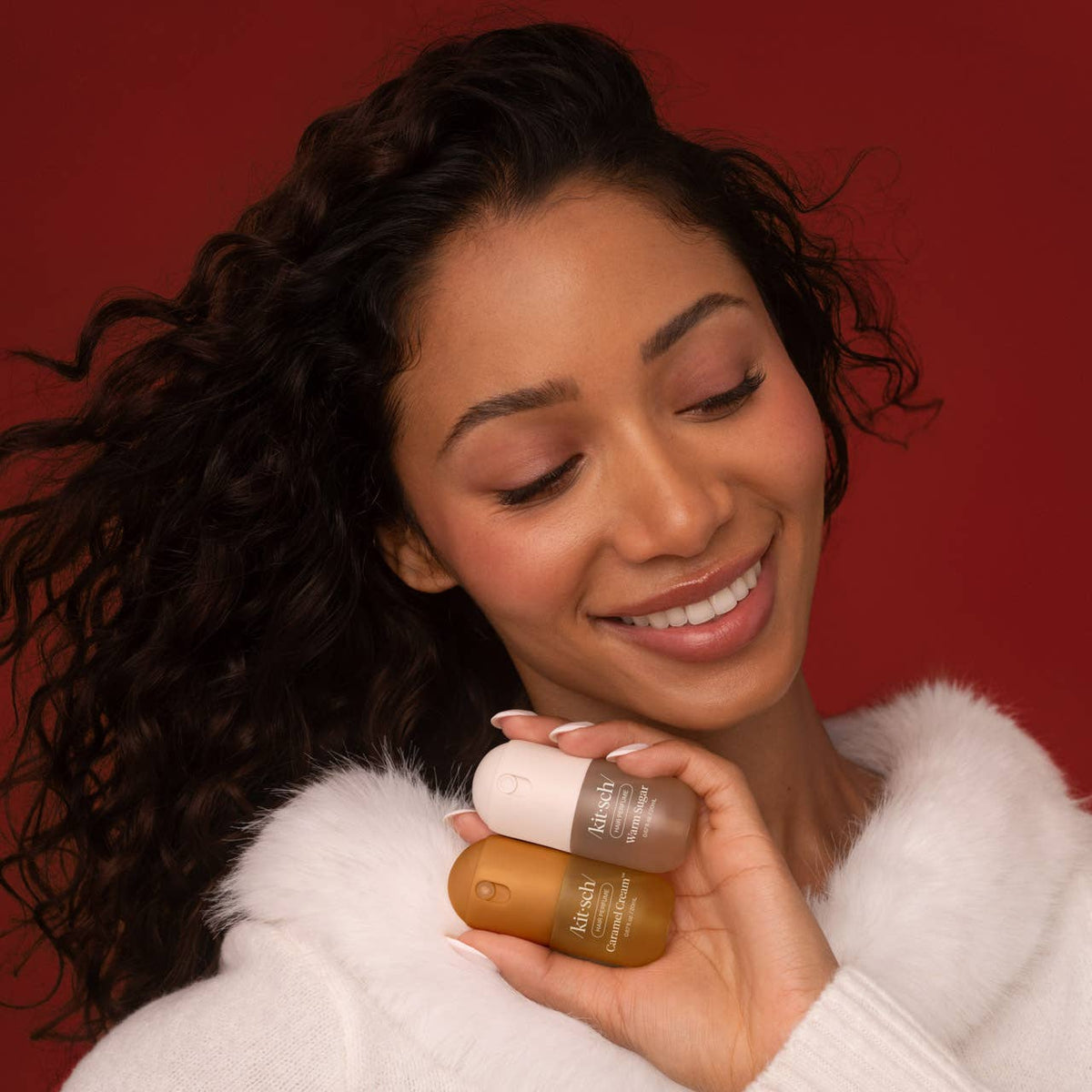 Kitsch Sweet and Silky set, smiling model holding both mini hair perfumes