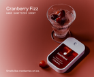 Touchland Cranberry Fizz Power Mist with a glass of cranberries, scent label graphic