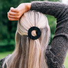 Teleties Jet Black Small Flat Circle Hair Clip worn in blonde half-up hair
