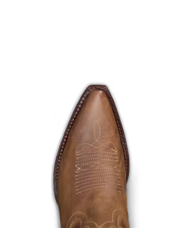 Close-up of a brown leather boot with intricate stitching on a black background. Tecovas women’s cowboy boots