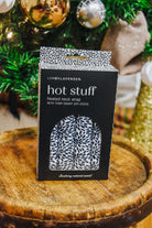 Lemon Lavender Hot Stuff Heated Neck Wrap in black and white print, boxed by a Christmas tree