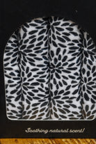 Hot Stuff Heated Neck Wrap in black and white, close-up of the leaf print through the box window
