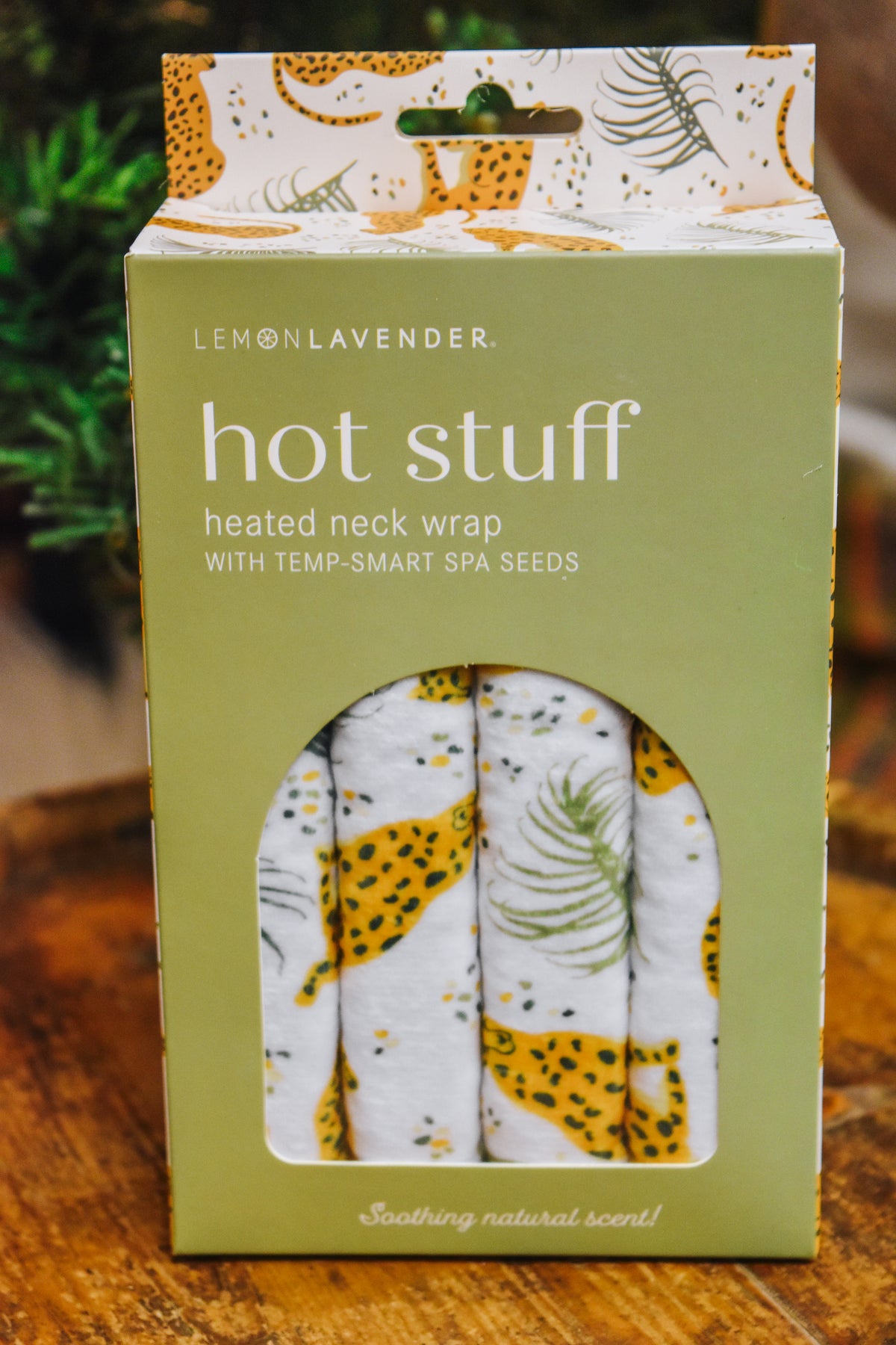 Hot Stuff Heated Neck Wrap in cheetah print, close-up of the green box front