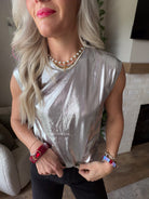 Close-up of the Dear John Charli Silver top showing its round neckline and shiny metallic-look texture.