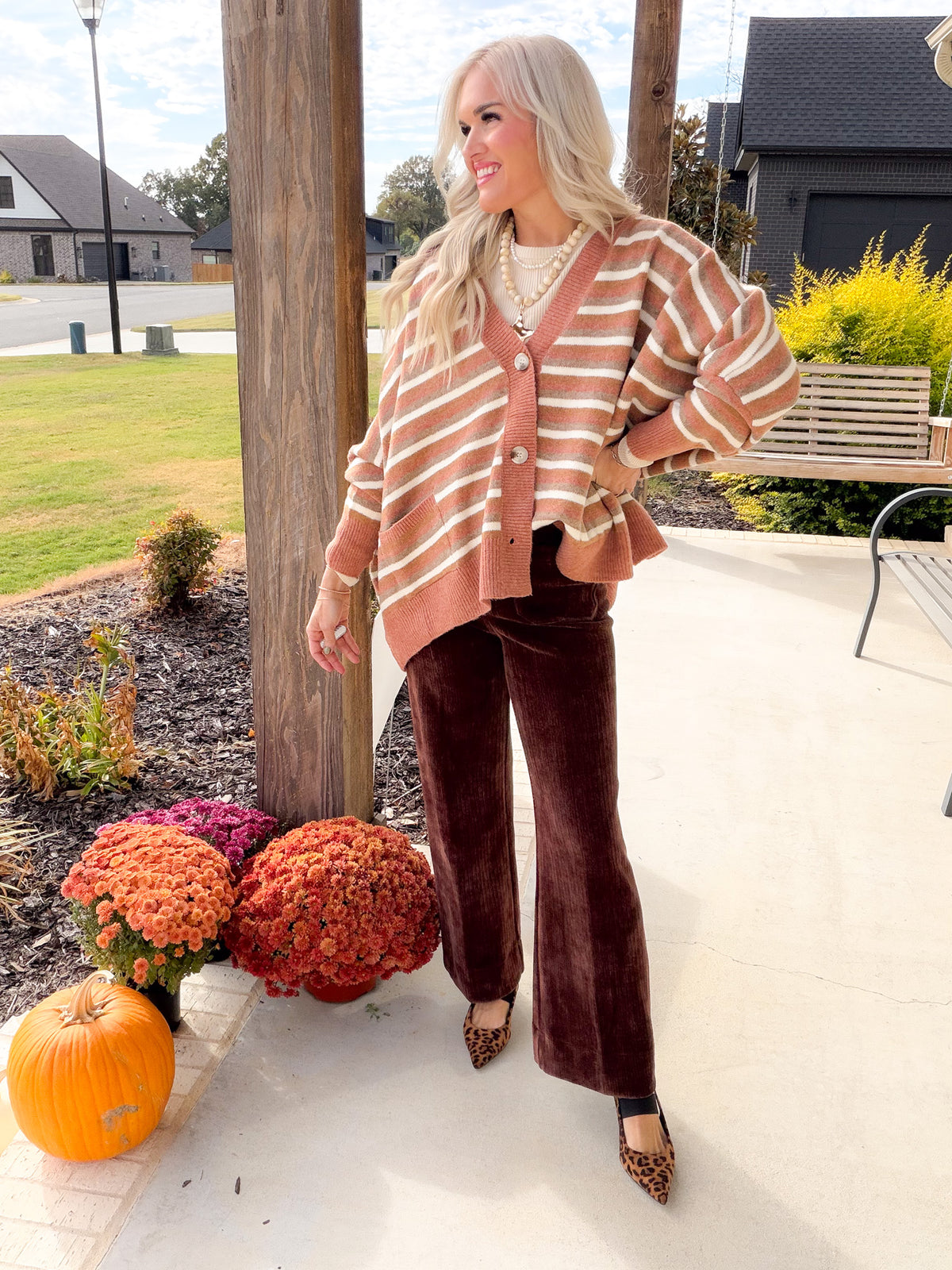 Camel Multi oversized striped cardigan styled with brown wide-leg trousers and leopard-print pointed-toe shoes.