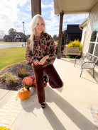 Brown Multi leopard print sheer button down shirt styled with brown wide-leg trousers and black heels.