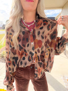 Close-up of the Brown Multi leopard print sheer shirt showing its collar, button front and lightweight woven fabric.