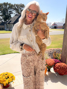 Model wearing the Chilliest Hour natural mineral wash shacket with printed pants while holding an orange cat.