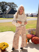 Chilliest Hour women's natural shacket buttoned up with printed wide-leg pants and sneakers.