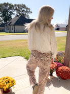 Back view of the short natural mineral wash shacket showing textured shoulders and sleeves with raw-edge seams.