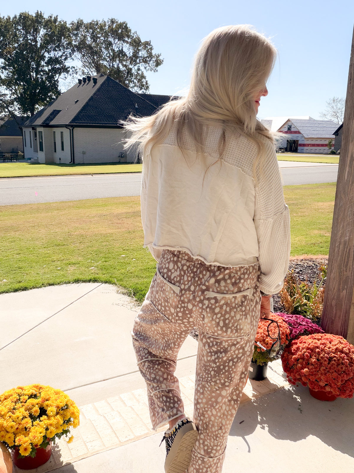 Back view of the short natural mineral wash shacket showing textured shoulders and sleeves with raw-edge seams.