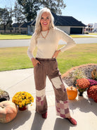 Women's chocolate patchwork pants with cream and paisley panels, styled with a cream top and burgundy shoes.