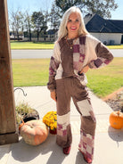 Model posing hand on hip in chocolate paisley patchwork sweatshirt and coordinating printed pants