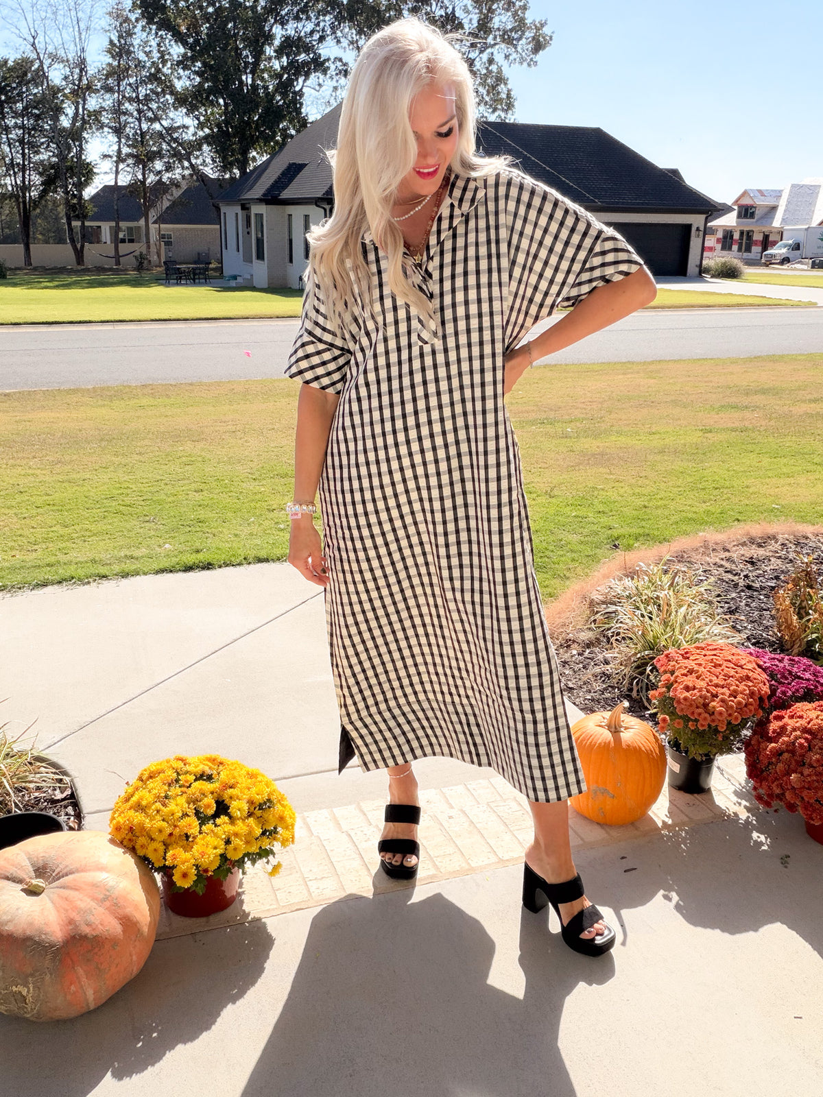Side Notes black-and-white gingham midi dress with short sleeves and side slits, styled with black block heels.