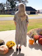 Back view of the Side Notes black-and-white gingham midi dress with short sleeves and a loose silhouette.