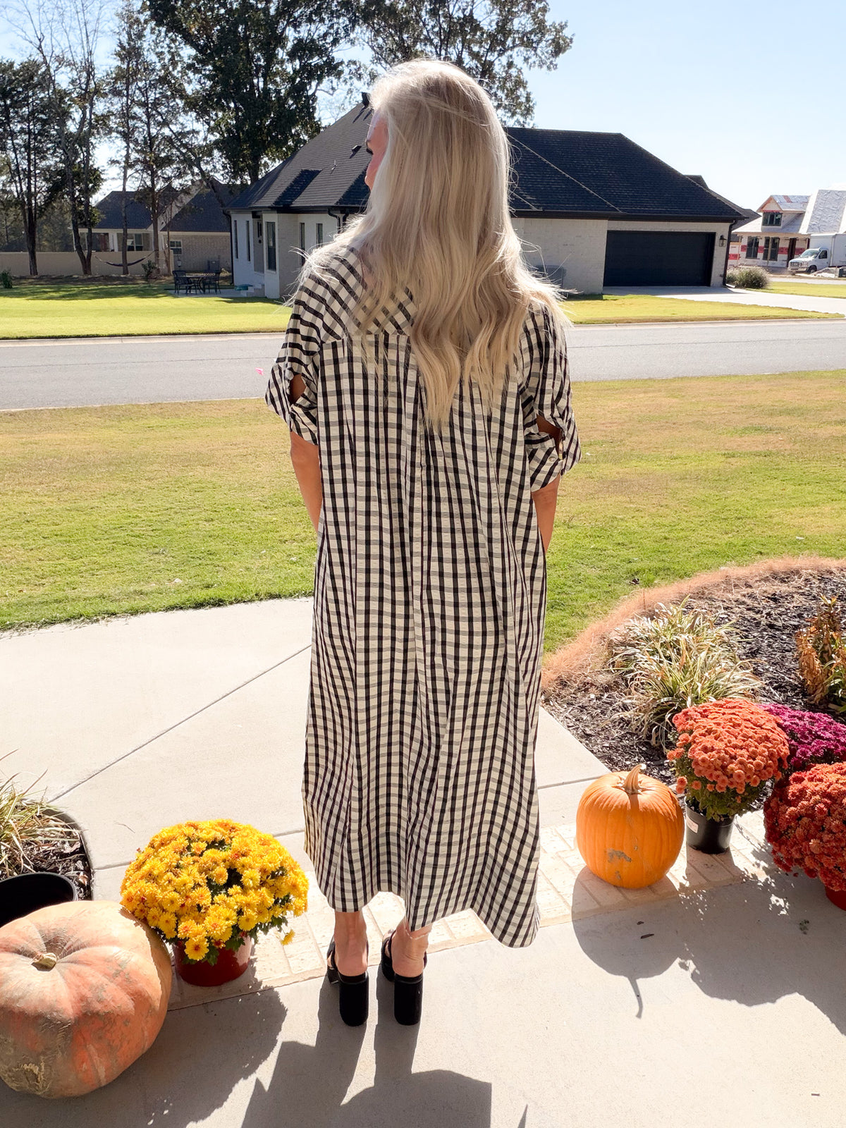 Back view of the Side Notes black-and-white gingham midi dress with short sleeves and a loose silhouette.
