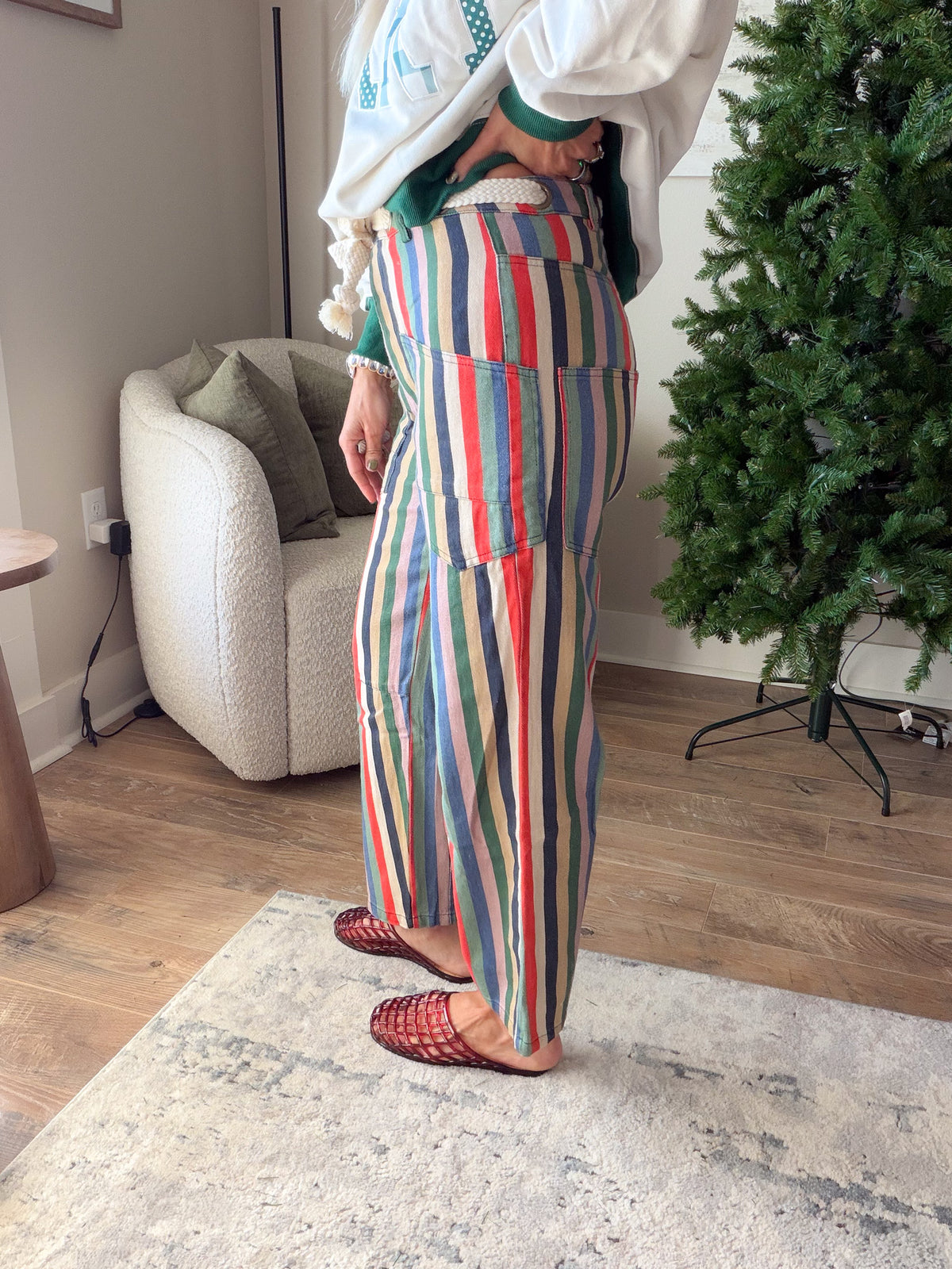 Side view of What's Your Narrative striped cotton jeans showing the front patch pocket and relaxed leg.
