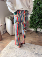 Back view of multicolor striped relaxed fit jeans showing the double-layered patch pockets and wide legs.