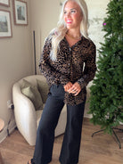 Dear John women's leopard print blouse with a partial front tuck, showing the collar and button-front design.