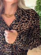 Close-up of Dear John Lolita blouse showing Noir Panthera leopard print, collar, front buttons, and button cuff.