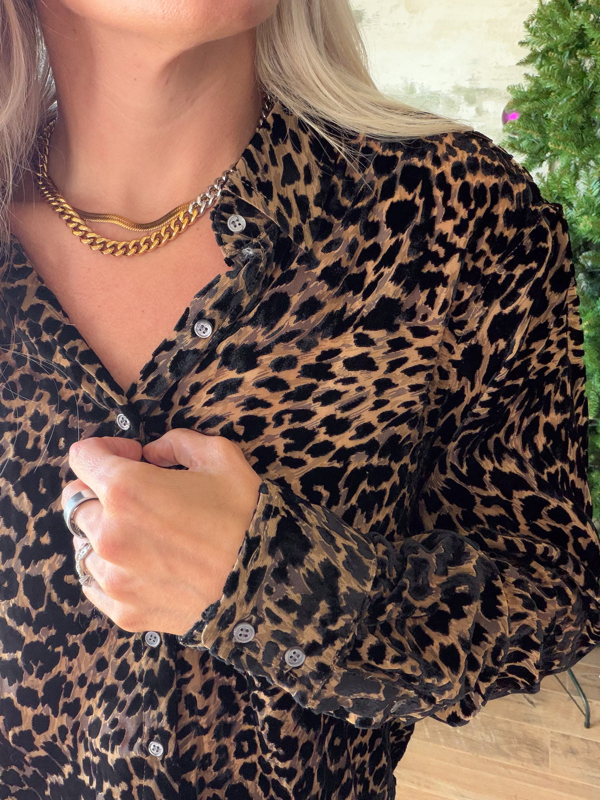 Close-up of Dear John Lolita blouse showing Noir Panthera leopard print, collar, front buttons, and button cuff.