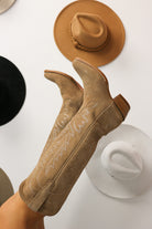 Tan cowboy boots with a white background. Tecovas women’s cowboy boots