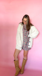 Oversized oatmeal chunky knit cardigan, button front, worn open over a graphic tee
