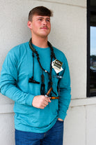 Drake Paracord Black and Olive Duck Caller's Lanyard worn around the neck, three-quarter view