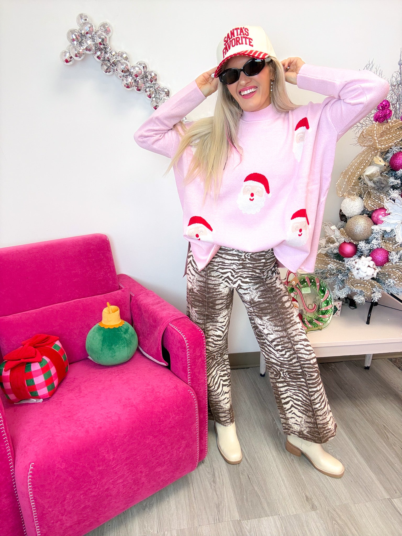 Mud Pie pink Santa jacquard sweater worn loose over zebra print pants, full-length front view