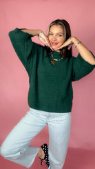 Sweet Nothings Hunter Green Sweater worn with light jeans, playful pose