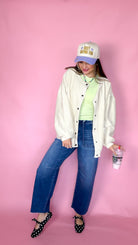 Covered In Goods ecru shacket with snap front, full-length view with jeans