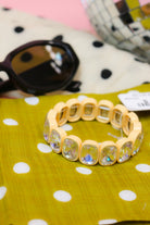 Billie Beaded Bracelet in beige with clear crystal stones, styled beside sunglasses and a disco ball