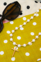 Lolly Pearl Beaded Gold Cross Necklace, close-up of the pearls and gold cross pendant