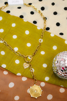 Laney Lariat Gold Charm Necklace, full length showing heart charm and sunburst medallion