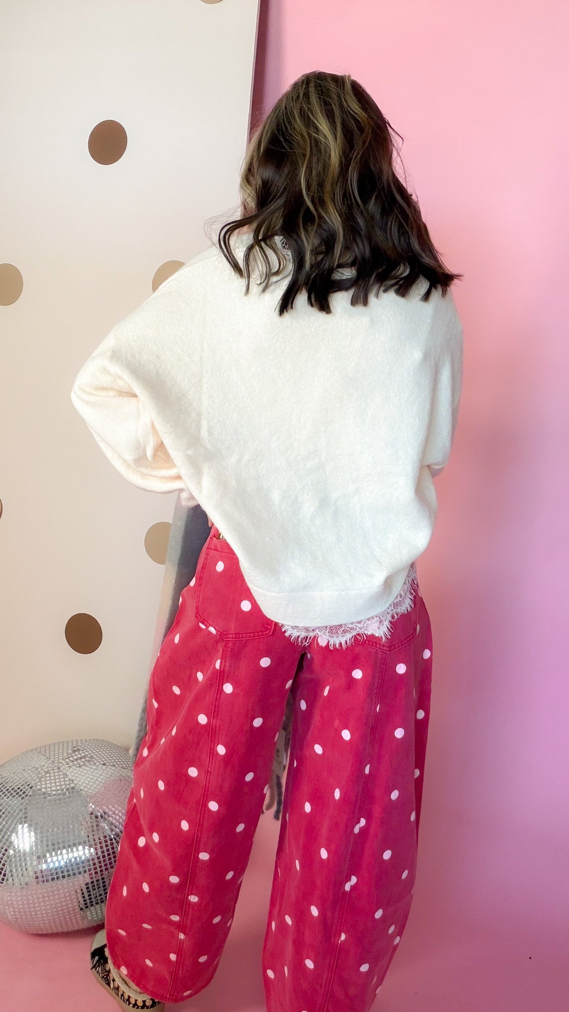 Back view of the Dotted All Around brick red polka dot barrel jeans