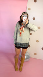 A Warming Welcome plaid hem sweater, mirror selfie full length