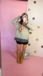A Warming Welcome sweater, mirror selfie with hand raised