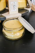Tyler Pineapple Crush small yellow candle with lid propped open