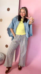 Daisy yellow ribbed tank top layered under a denim shirt with plaid pants, model facing forward.