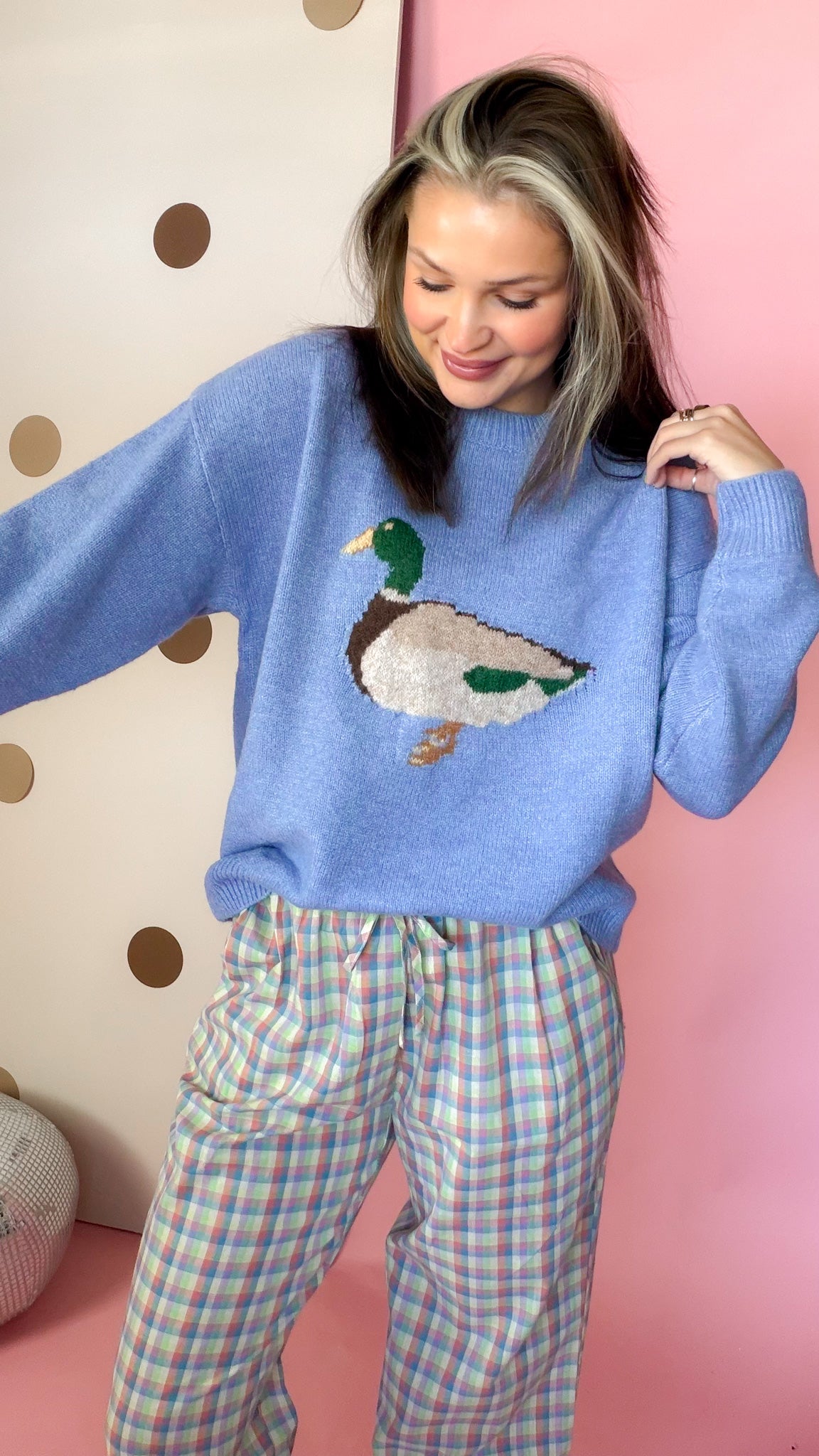 Coastal blue duck sweater showing the crew neckline, mallard motif, and ribbed sleeve cuff.