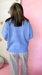 Back view of the coastal blue women's sweater showing the plain knit back, drop shoulders, and ribbed hem.